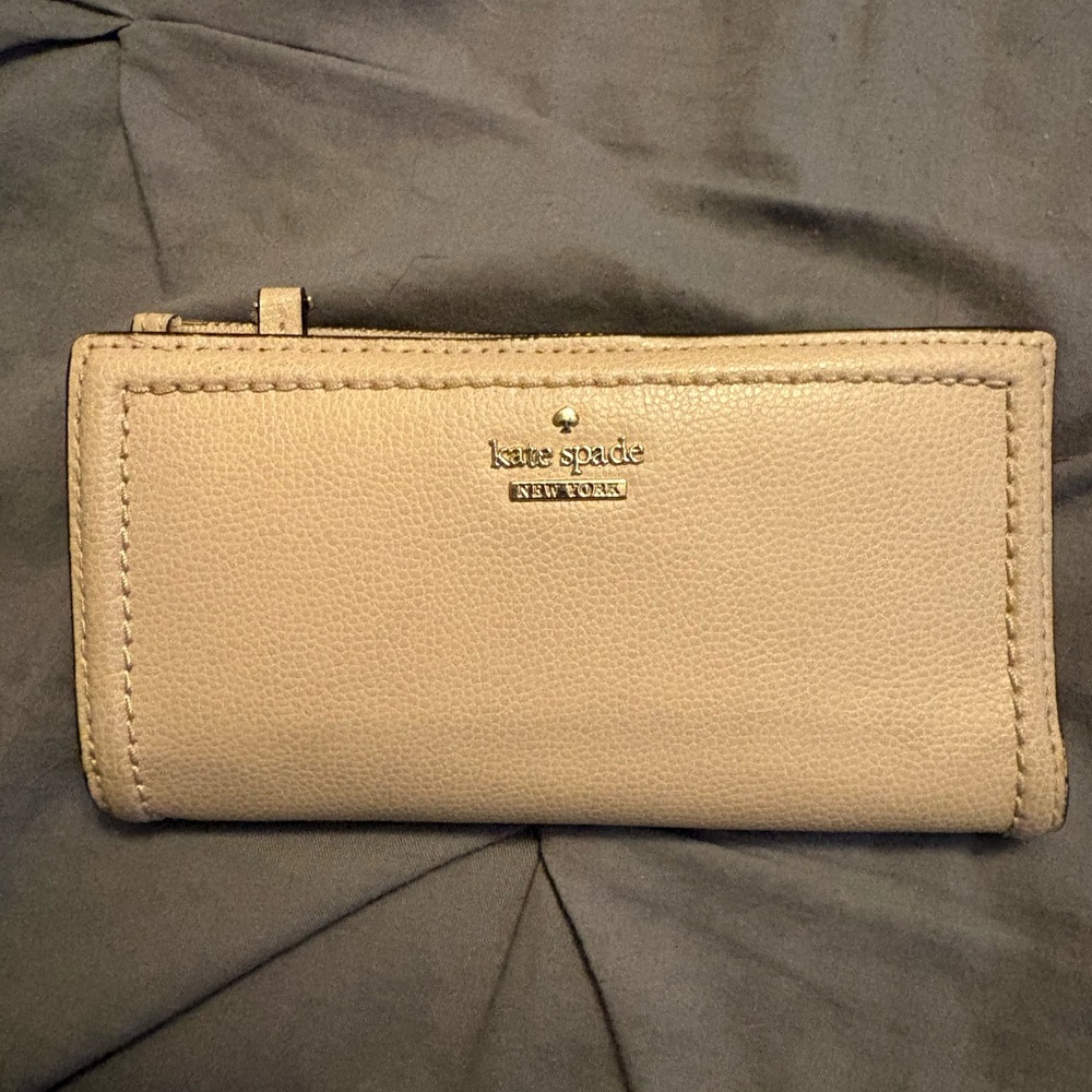 kate spade “Staci”pebble leather zip-around wallet in taupe with gold logo